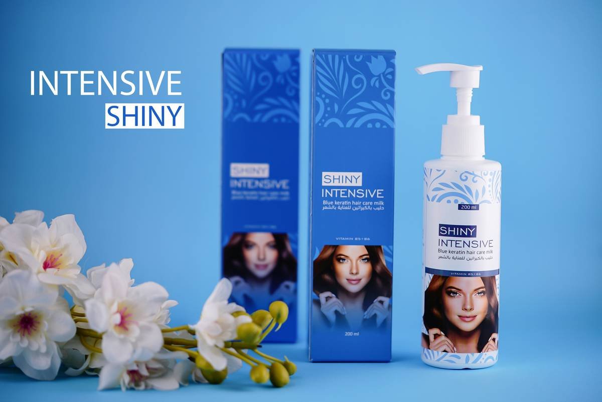 Model using shine serum before securing hair with decorative clip